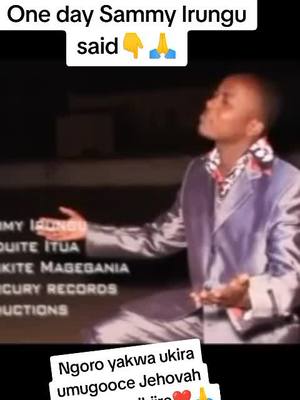 The image is a screenshot of a man singing, seen from the chest up. The man, dressed in a purple suit with a patterned shirt, is in a performance or studio setting. A text overlay at the top reads, 'One day Sammy Irungu said'. Below the man on the left side are credits. At the bottom, another overlay in Kikuyu reads 'Ngoro yakwa ukira umugooce Jehova'.