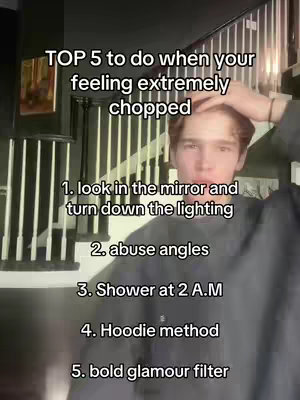 A vertical video cover image featuring a young man with light skin, brown hair and a neutral expression, holding his right hand up and touching his hair. The background includes white stairs and black banisters, suggesting a home setting. The text overlay is in white font against a dark backdrop that lists the top 5 things to do when you're feeling extremely chopped.