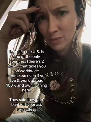 A woman with long brown hair looks at the camera with a concerned expression while gesturing with her hand. Text overlays appear on the left side of the screen.
