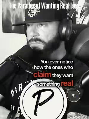 A black and white image features a man in a black cap and headphones against a dark background. Text overlays the image. The man looks down thoughtfully. A circular logo, with a letter "P" is in the lower center. Other text elements include, "The Paradox of Wanting Real Love" at the top, and, "You ever notice how the ones who claim they want something real" across the image.