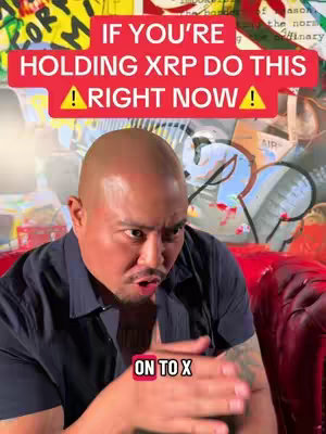 A man with a shaved head, wearing a black shirt, is looking at the camera with a slightly concerned expression. Above his head, there is a red bar with white text: 'IF YOU'RE HOLDING XRP DO THIS RIGHT NOW'. Underneath is the text 'ON TO X'. The background consists of an abstract, colorful mural. The man is sitting in front of a red sofa.