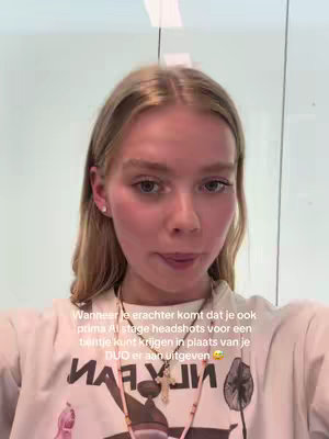 A selfie-style shot of a young woman with blonde hair, looking towards the camera. She is wearing a white t-shirt with a graphic design, and a necklace with a cross pendant. Text overlays are at the bottom of the image. The background is a light, neutral tone.