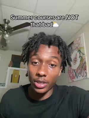 A young Black man with short, textured hair is centered in the frame. Above him, text overlays read "Summer courses are NOT that bad". He's wearing a black shirt and is looking at the camera. The background shows a ceiling fan, a painting, and a jersey framed.