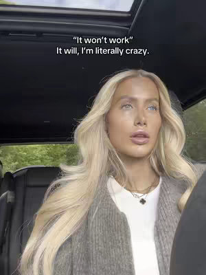 The cover image shows a woman with long blonde hair seated inside a car. She is looking towards the upper right-hand corner with a neutral expression. The car has a sunroof. Text overlays on the top of the image.