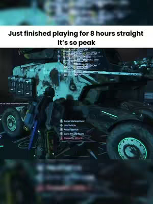 The image showcases a scene from a video game featuring a large, armored vehicle with detailed textures and lighting. A character is visible near the vehicle, seemingly interacting with the game's user interface, which is partially visible on the screen. The overall composition is dark, with a focus on the futuristic design of the vehicle and digital interface elements. The colors are muted, giving the scene a realistic, possibly post-apocalyptic, tone.