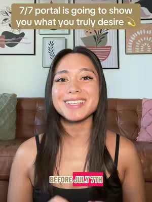 A woman with long dark hair smiles directly at the camera, set against a backdrop of framed artwork on a wall. The video includes text overlays: one at the top that reads "7/7 portal is going to show
you what you truly desire," and another at the bottom, stating "BEFORE JULY 7TH."