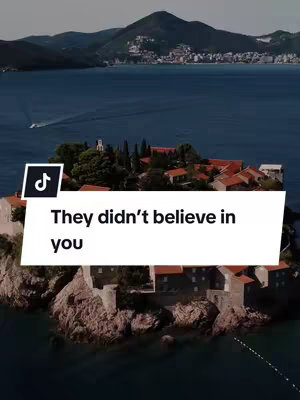 An aerial view shows an island with buildings densely packed together, surrounded by water. The background includes dark mountains and a distant city. A white overlay with the text 'They didn't believe in you' is positioned over the island. The TikTok logo is in the top left corner.