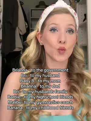 A selfie-style shot of a woman, with blonde hair and wearing a white headband, looking towards the camera with a soft, pouting expression. Text overlays list nicknames.