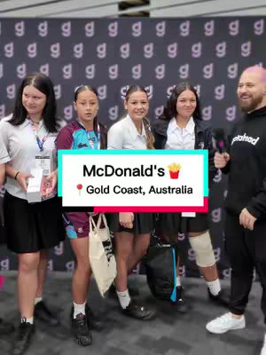A group of young people in a casual setting are being interviewed by a man holding a microphone. A text overlay provides the McDonald's location.
