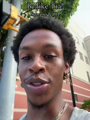 A selfie-style shot featuring a person with dark, curly hair and gold earrings against an outdoor background. The person is looking directly at the camera, with text overlayed at the top.