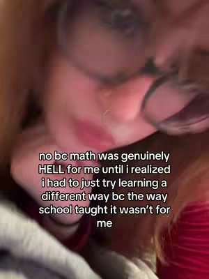 The cover image is a close-up shot, likely a selfie, focusing on the face of a person with glasses. The person has fair skin and red lips, with a portion of their reddish-brown hair visible. The background is blurred, suggesting a casual setting. Text overlayed on the image discusses the frustrations with traditional math education and the need to try a different learning approach.
