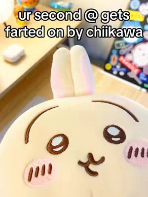 The cover image features a light yellow plushie of a bunny character. The plushie has large, round dark brown eyes, pink blush marks, and small, dark brown embroidered details representing its nose and mouth. Two white and pink ears extend upwards from the top of the plushie's head. The background is blurred, but includes a glimpse of a light-colored surface and a few other objects. Overlayed on the image is white text.