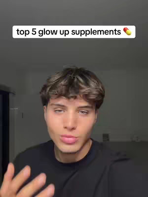 A young man with light skin and light brown, styled hair gazes directly at the camera, the upper part of his body filling most of the frame. The background is a blurred, neutral shade, providing contrast. Above his head, a white rectangular bar contains dark text stating "top 5 glow up supplements" followed by an emoji of a capsule.