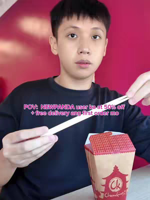 A young man holding chopsticks, looking towards the camera with a serious expression in front of a pink background. A branded takeout box is partially visible. The image has a text overlay in a pink box that is above the creator reading 'POV: NEWPANDA user ka at 50% off + free delivery ang first order mo'