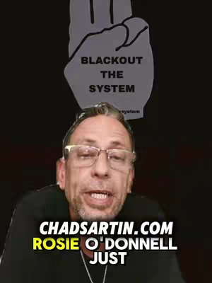 The cover image features a man with glasses looking towards the camera with text overlays, with a graphic of a hand with 2 fingers extended and the words "BLACKOUT THE SYSTEM" overlayed above his head.