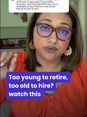 A woman with glasses is speaking directly to the camera. Overlaid on the image is a rectangular graphic in a light blue color with white text. The background includes a blurred interior with what appears to be a kitchen.