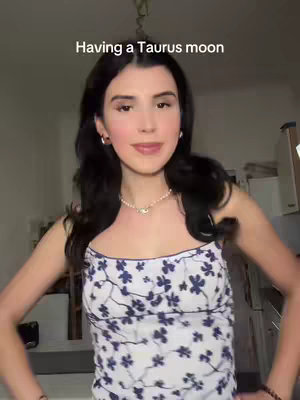 A woman with long dark hair, wearing a flowered tank top, stands in front of an out-of-focus light colored background. Text overlay at top.