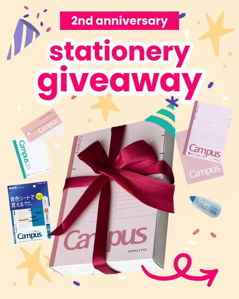 A promotional image for a stationery giveaway, featuring a large gift box wrapped with a burgundy ribbon, surrounded by stationery items like notebooks and pens. The background is a light peach color with celebratory elements like confetti and stars.