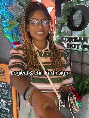 A person with curly brown hair, glasses, and a striped shirt smiles at the camera. Text overlays the image, and a blurred background includes plants and restaurant decor.