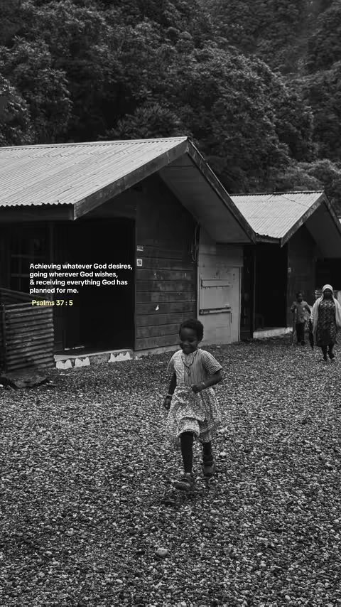 A black and white photo depicts a young girl running towards the viewer in a rural setting. She wears a patterned dress and there are small buildings with corrugated metal roofs in the background. The foreground is covered in gravel. Text overlays the image, providing an inspirational quote and a Bible verse reference.
