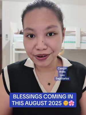 A selfie-style video cover featuring a woman looking directly at the camera. Text overlays include the text 'Blessings coming in this August 2025' inside a blue rectangle and a smaller box indicating Cancer, Aries, Leo, Sagittarius. The background behind the woman features an interior setting.