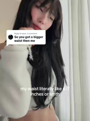 The cover image features a young woman with long, dark hair and bangs, wearing a white top. She is positioned in front of a neutral background, possibly a wall or curtain. The text "my waist literally like 6-7 inches or smth" is overlaid on the image. A comment box is also visible in the upper left corner.