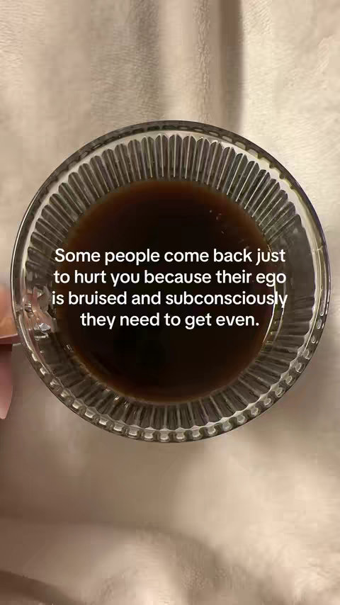 The image is a top-down view, featuring a clear glass bowl filled with a dark brown liquid, possibly coffee or a similar beverage. The bowl has a textured, wavy design on its exterior. The liquid inside occupies most of the bowl's space and appears to be still. The background is a light, blurred surface, and the lighting is soft and diffused, giving the image a calm, neutral feel.