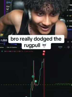 A young man with curly black hair is reacting to a trading chart displayed on a computer screen. Text over the image reads, 'bro really dodged the rugpull'. The man wears a black shirt and a headset, with the background showing a gaming setup.