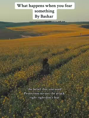 A landscape shot of a field of yellow flowers under a blue sky. In the distance, there are green hills. A blurred figure is seen walking through the flowers.