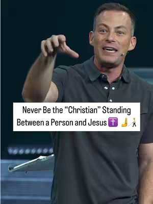 The cover image shows a man on a stage, gesturing with his right hand. He is wearing a dark grey polo shirt and has short hair. Above him is a white rectangular text overlay containing the words: Never Be the Christian Standing Between a Person and Jesus. Two emojis are also present on this overlay. The background is dark, suggesting a performance setting.