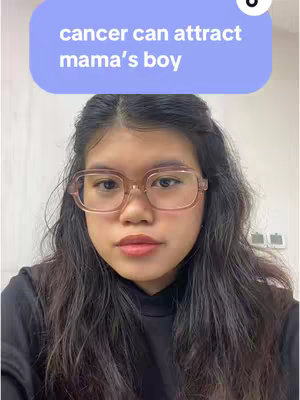 A selfie-style shot featuring a young woman with glasses in front of a neutral background.