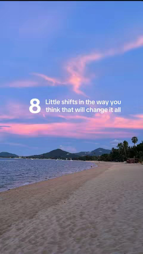 A serene beach scene at sunset with a vibrant sky. The sky is a gradient of blues and pinks, with a few clouds. In the foreground is a sandy beach, and in the distance are mountains and palm trees. The composition is balanced and peaceful.