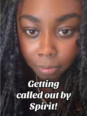 A close-up image of a woman's face. She has dark skin and is looking towards the camera with a slight, neutral expression. Her dark hair, styled with large twists or braids, frames her face. The top portion of the image shows her eyebrows and the upper part of her forehead. The image has text overlaid in white, with a bold font, and partially obscures her lower face.