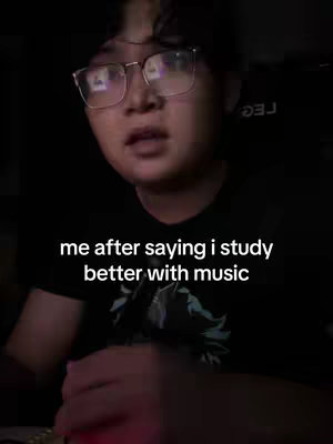 A person wearing glasses looks at the camera with a slightly distressed expression. Overlayed text reads, "me after saying i study better with music."