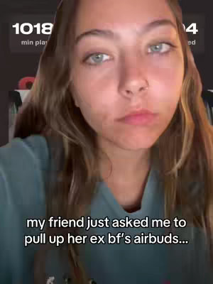 A young woman with long brown hair is looking at the camera with a slightly concerned expression. Overlayed on the top is the app's playtime, and a snippet of text towards the bottom. The background is blurred, suggesting an indoor setting.