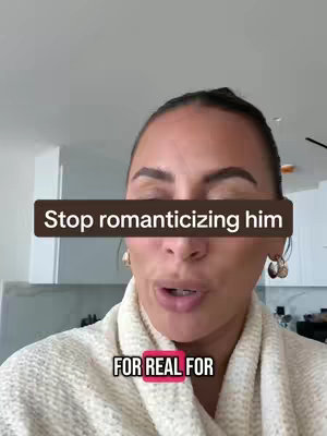 A woman is in the foreground and a text overlay spans across her face. She has dark hair and is wearing a white sweater and hoop earrings. The background appears to be a kitchen setting.