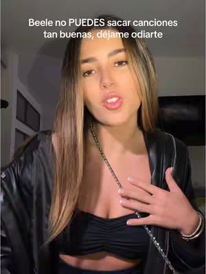 A woman with light brown hair and a black outfit is the central focus, framed against a blurred background. Text overlays appear on the image in white font.