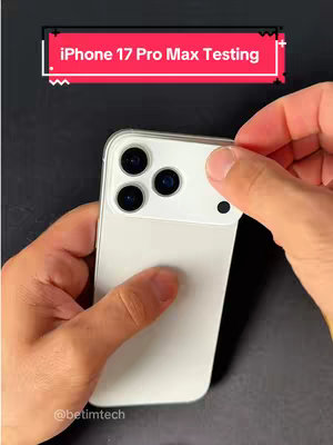 The cover image shows a person's hands holding a prototype iPhone, with a white back and a camera module featuring three lenses. The phone appears to be sitting on a dark surface. The creator's hands are holding the phone from the top, with the background having a dark appearance.