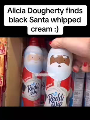 The cover image features a person's hand holding a Reddi-wip can with a black Santa Claus face on it. It is placed near several others. The image also contains overlay text, and the background shows a retail store.