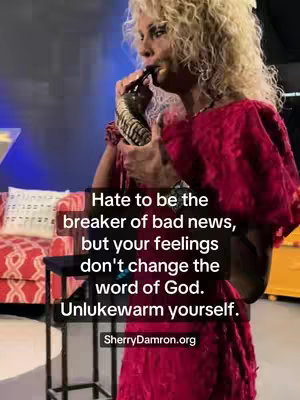 A woman with blonde curly hair, wearing a red dress, holds a black object up to her face, appearing to speak into it. Text overlays on the image provide a message.