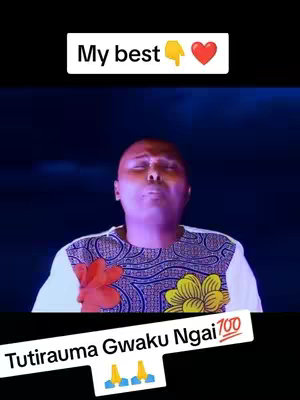 A man with a bald head is singing while facing upward, with a dark blue background that has light orbs. He is wearing a white shirt with a colorful pattern on the shoulders and a white collar. Superimposed on the image are text overlays.