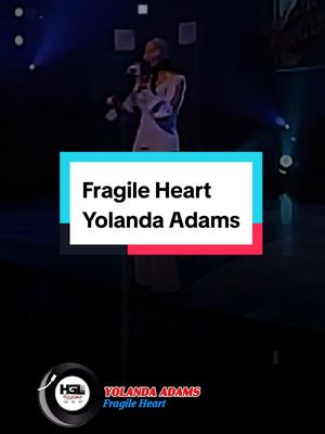 The cover image displays a mid-shot of a woman, presumably Yolanda Adams, performing on stage. She is holding a microphone and singing. Overlayed on top is a rectangular box with text indicating the song title and artist. Below is a circular logo, and additional artist and song information.