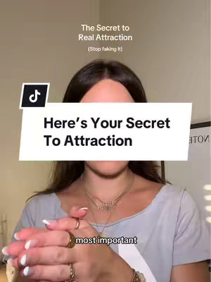 The image shows a person, likely the creator, with the upper body visible. She is wearing a light-colored top and jewelry, including necklaces and rings. A white banner with black text reading, "Here's Your Secret To Attraction" covers most of her mid-section. Above the banner, text that reads "The Secret to Real Attraction (Stop faking it)". The TikTok logo is visible in a corner.