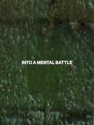 The image is a vertical shot featuring a dense, green, textured background that resembles either moss and leaves, or a blurred, abstract representation of foliage. Centered on the image is the white text overlay 'INTO A MENTAL BATTLE'. The composition is simple, with the focus primarily on the background texture and the overlaid text.