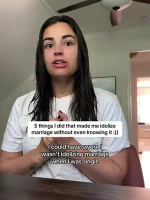 A woman with long dark hair and a white shirt is centered in the frame, looking towards the camera. Text overlays appear in the image explaining the video content. The background is subtly blurred, suggesting an interior setting.