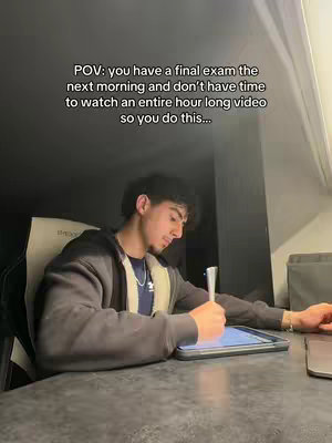 A young man is sitting at a desk, leaning over a tablet with a stylus in hand. The scene is dimly lit, suggesting a late night study session. The text overlay reads, "POV: you have a final exam the next morning and don't have time to watch an entire hour long video so you do this..."