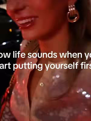 The cover image shows a close-up of a woman's face, with a focus on her smiling mouth and one earring in a golden hoop. The upper portion of her body is visible, partly obscured by a shimmering, light-colored top. Text overlayed on the image reads, "How life sounds when you start putting yourself first." Red highlights the lips.