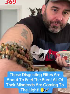 A man holds a handful of tarot cards. He is wearing a black t-shirt, a dark baseball cap, and has a beard. A blue text box at the bottom contains the text hook. The background includes objects on a white surface.