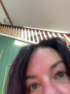 The cover image shows a close-up of a person's face, specifically focusing on their eyes and forehead, with dark hair and a slightly angled perspective. The upper portion of the image includes a part of a ceiling, wooden beams and a white light.