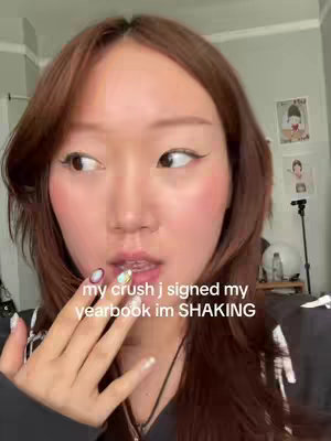 A young woman with long brown hair and makeup looks slightly to her left, lips parted. Text overlay is on the image.